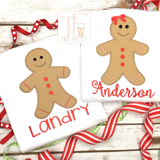 two personalized gingerbread cookies on white towels